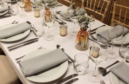 Grey and white table settings with amber accessories and gold tea light holders