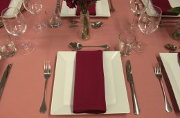 Pink table cloths and burgundy napkins