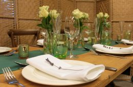 Rustic trestle table with white roses, green table runners and lavender