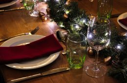 Rustic trestle with a Christmas theme, green glasses and burgundy napkins