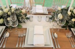 Square white crockery with Verdi cutlery, Reserva glassware and rustic furniture