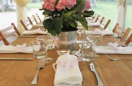 Coupe glasses on a rustic table with Verdi cutlery and white table linen